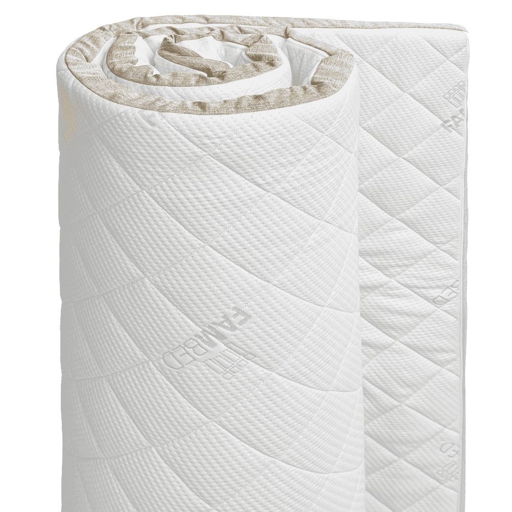 Surmatelas FAMBED en latex naturel, partiellement enroulé, avec une housse blanche matelassée et une bordure couleur lin